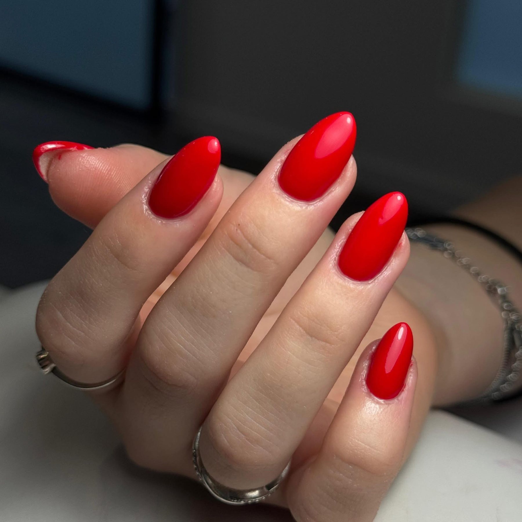 Rood gelakte amandelnagels, close-up van een hand